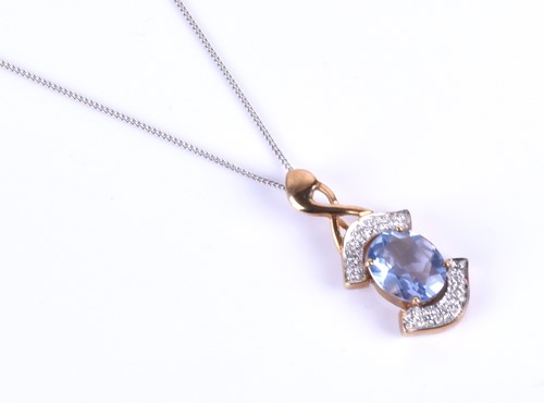 Lot 395 - A 9ct yellow gold and blue topaz pendant,...