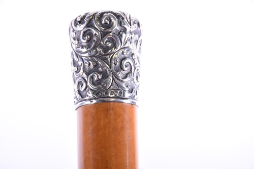 Lot 435 - A silver-topped malacca cane with repousse...
