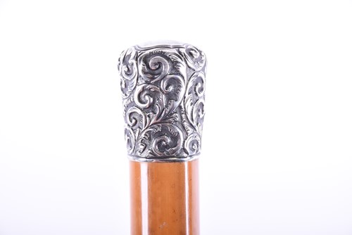 Lot 435 - A silver-topped malacca cane with repousse...