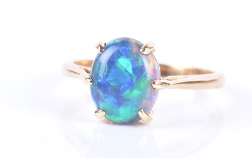 Lot 13 - An 18ct yellow gold and opal ring set with an...