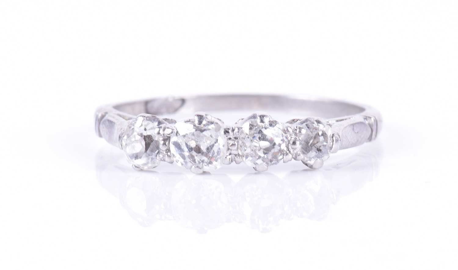 Lot 20 - A four-stone diamond ring set with four...