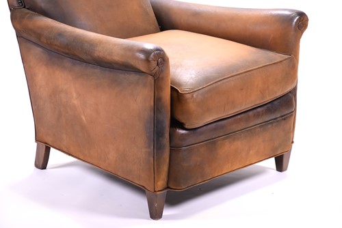 Lot 527 - A tan leather club armchair with padded seat...
