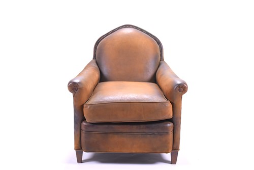 Lot 527 - A tan leather club armchair with padded seat...