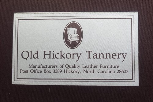 Lot 527 - A tan leather club armchair with padded seat...