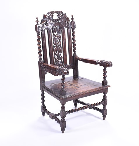 Lot 515 - A 19th century oak armchair, the back carved...