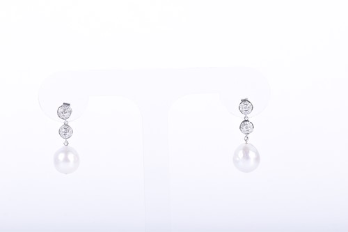 Lot 84 - A pair of diamond and pearl drop earrings each...