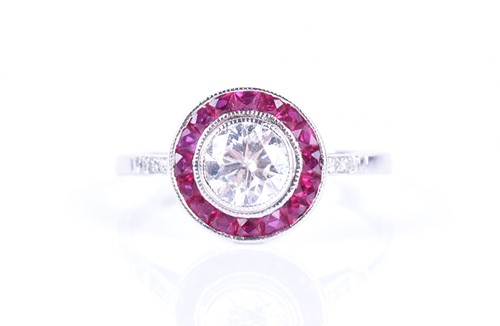 Lot 91 - A diamond and ruby target ring in the Art Deco...
