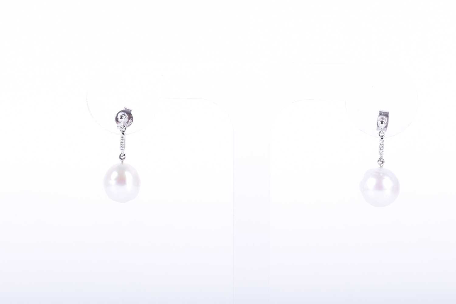 Lot 95 - A pair of 18ct white gold, diamond, and pearl...