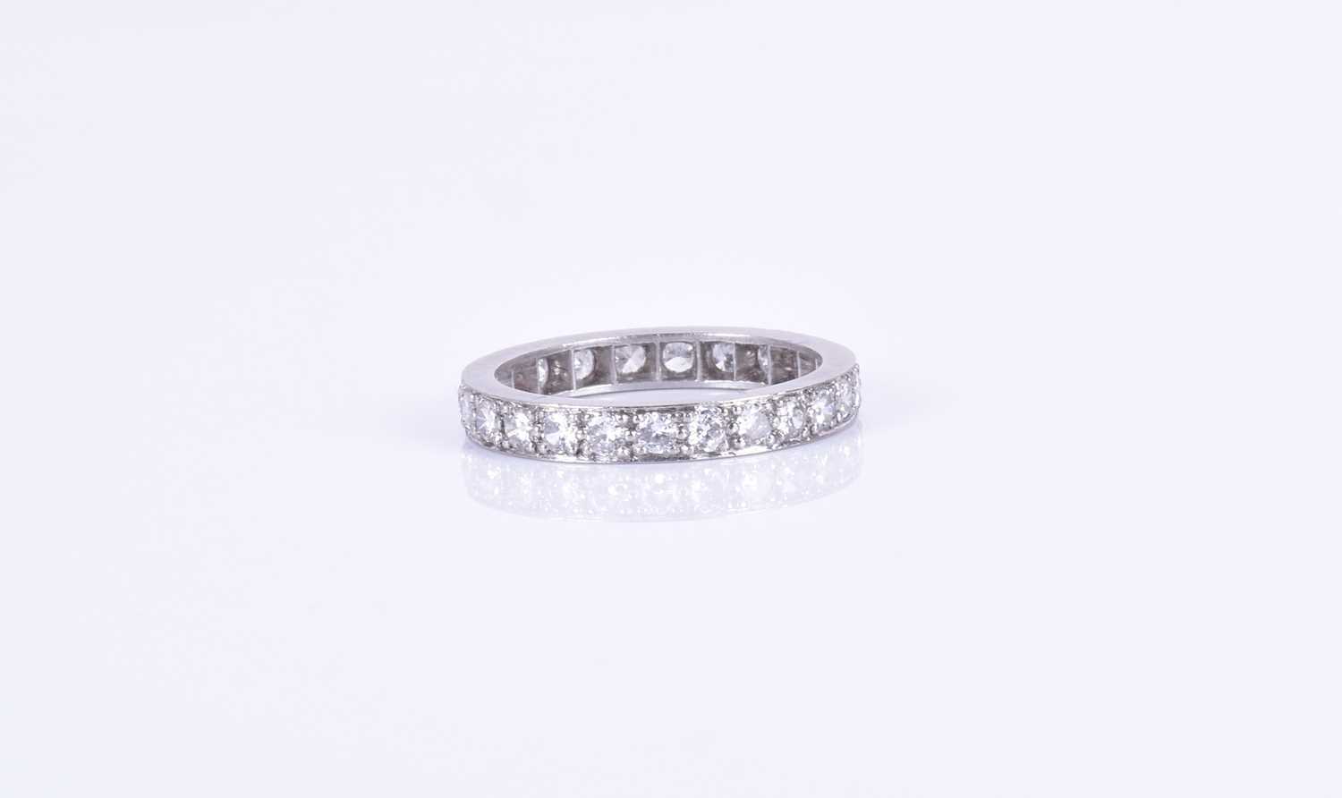 Lot 134 - A diamond eternity ring set with 23 round...