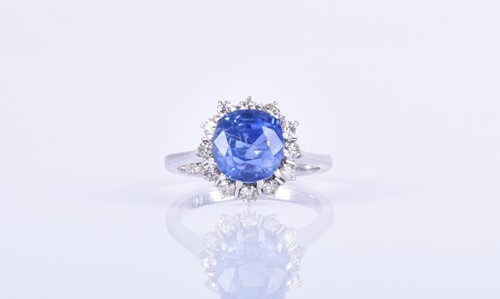 Lot 135 - An 18ct white gold, diamond, and blue sapphire...
