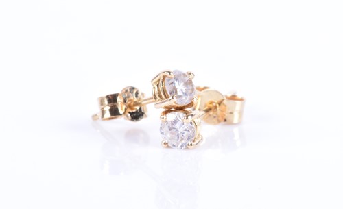 Lot 144 - A pair of solitaire diamond ear studs the...