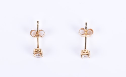 Lot 144 - A pair of solitaire diamond ear studs the...