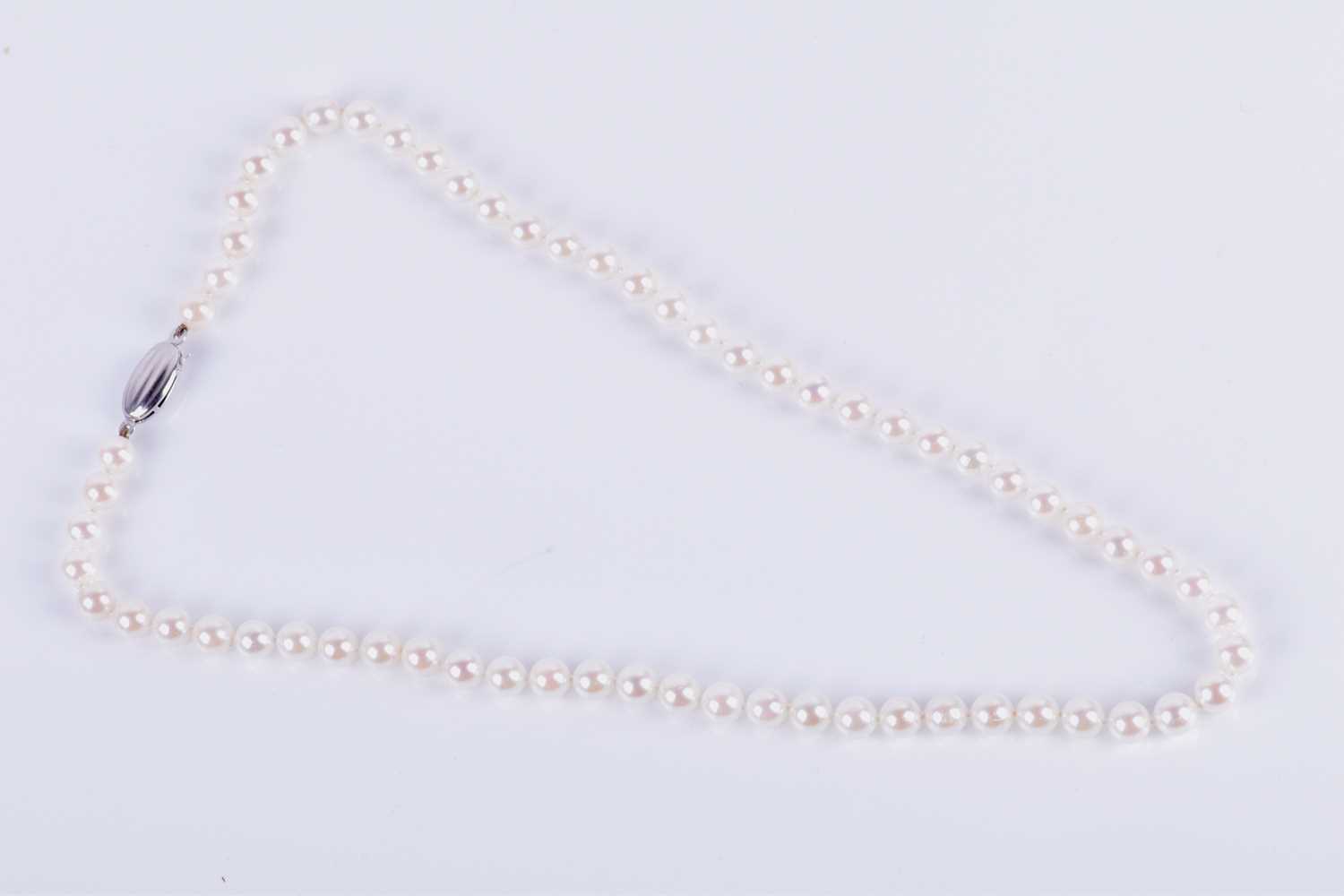 Lot 153 - A white pearl necklace comprised of rounded...