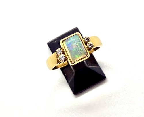 Lot 305 - An 18ct yellow gold opal and diamond ring, the...