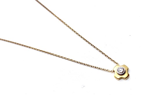 Lot 266 - An 18ct yellow gold diamond pendant on a trace...