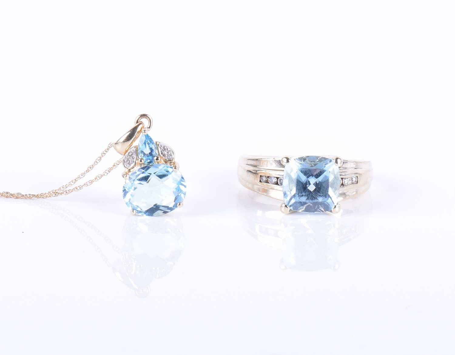 Lot 274 - A 9ct yellow gold, diamond, and blue topaz...