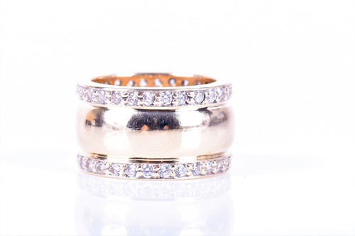 Lot 281 - A yellow metal and CZ eternity band ring inset...