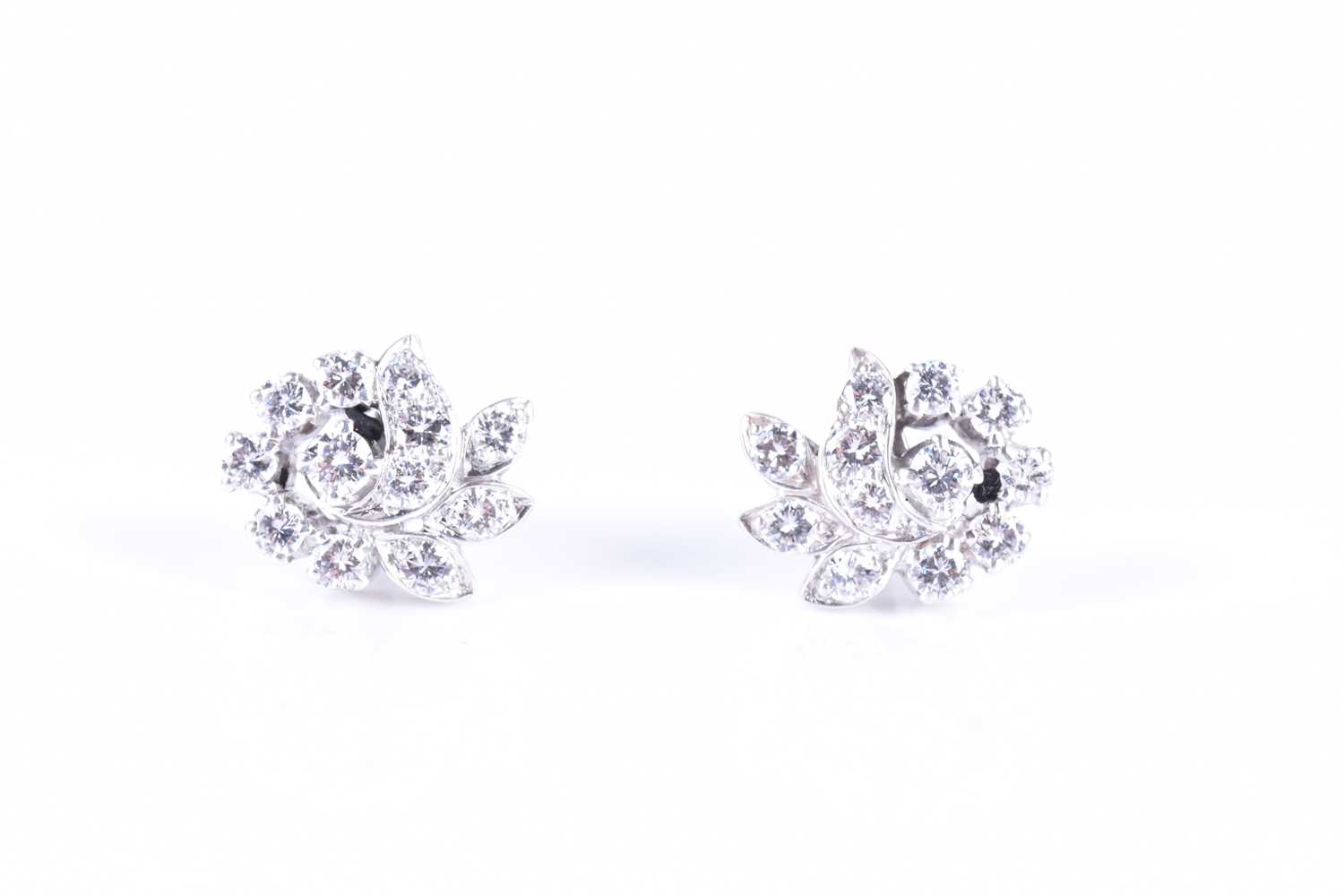 Lot 286 - A pair of diamond swirl cluster earrings set...