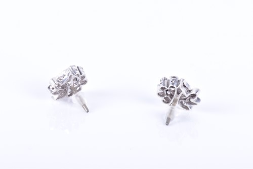 Lot 286 - A pair of diamond swirl cluster earrings set...