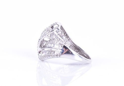 Lot 289 - A white gold and diamond swirled crossover...