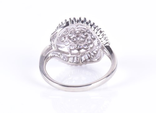 Lot 292 - A white metal and diamond swirl cluster ring...