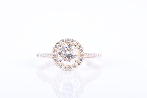 Lot 666 - A 14ct yellow gold and diamond halo ring...