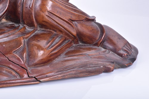 Lot 547 - A Chinese carved wooden model of a reclining...