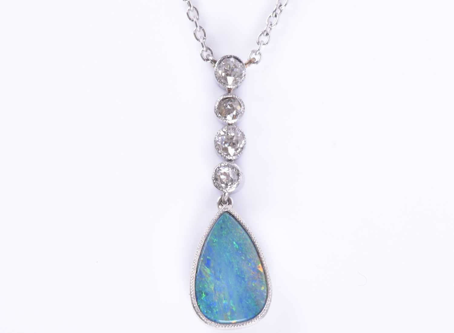 Lot 322 - An 18ct white gold, diamond, and opal pendant...