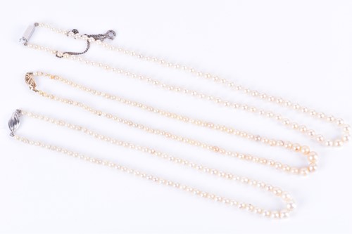Lot 341 - Three pearl necklaces of cultured pearls, one...