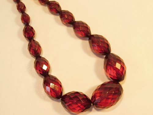Lot 356 - A string of faceted olive shaped graduated...