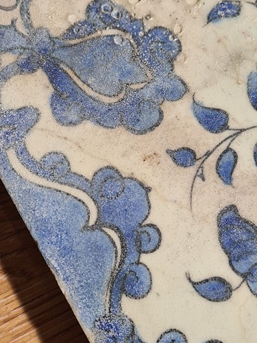 Lot 187 - A Persian pottery blue and white tile,...