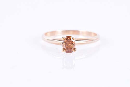 Lot 645 - A 14k yellow gold and solitaire diamond ring...