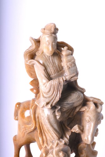 Lot 225 - A Chinese carved soapstone figure of Guan Yin,...
