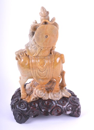 Lot 225 - A Chinese carved soapstone figure of Guan Yin,...
