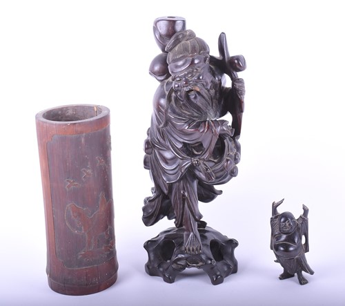 Lot 257 - A Chinese carved hardwood figure of Shou Lao,...