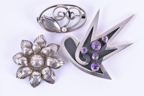Lot 203 - Georg Jensen. A silver floral brooch of oval...