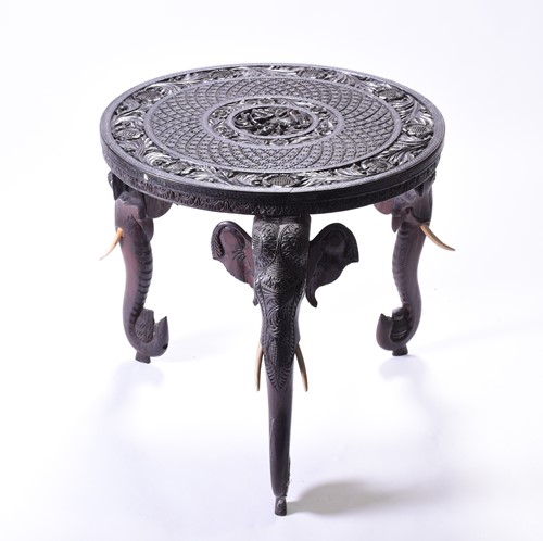 Lot 166 - An Indian carved ebony occasional table, the...