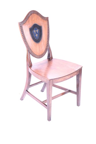 Lot 109 - A 19th century mahogany hall chair, the shield...