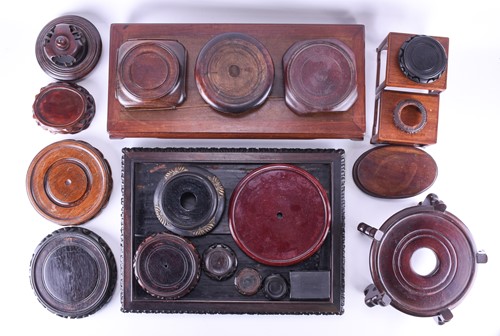Lot 222 - A collection of Chinese carved hardwood stands,...