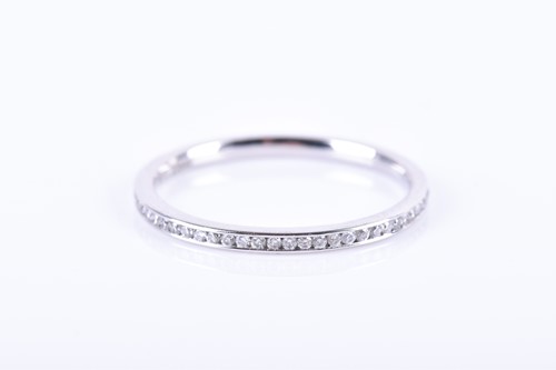 Lot 531 - A platinum and diamond eternity ring,...