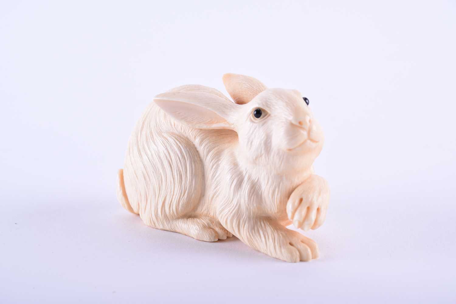 Lot 202 - A good Japanese carved ivory okimono of a hare,...