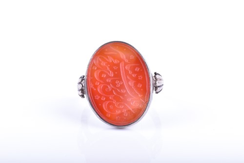 Lot 598 - A white metal and carnelian ring the oval...