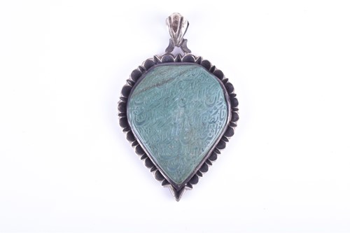 Lot 766 - A white metal and green hardstone pendant of...