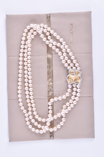 Lot 690 - A Bucherer Akoya triple strand pearl necklace,...