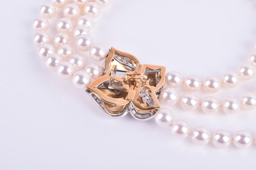 Lot 690 - A Bucherer Akoya triple strand pearl necklace,...