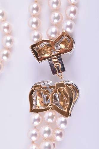 Lot 690 - A Bucherer Akoya triple strand pearl necklace,...