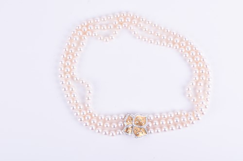 Lot 690 - A Bucherer Akoya triple strand pearl necklace,...
