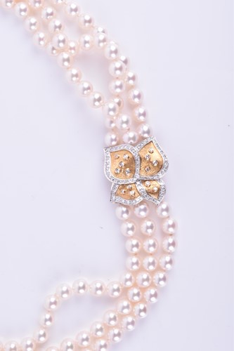 Lot 690 - A Bucherer Akoya triple strand pearl necklace,...