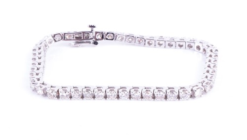 Lot 656 - A 14ct white gold and diamond tennis bracelet...