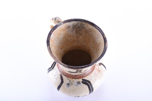 Lot 169 - An early Islamic tin glazed ewer, with...